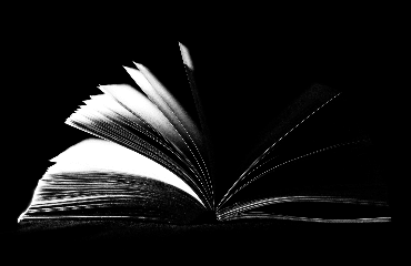 A black and white photo of an open book.